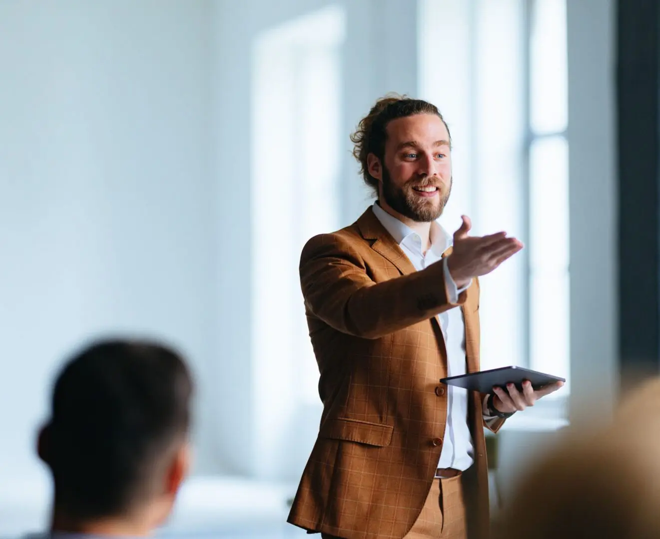 Man giving a presentation with a tablet in hand.