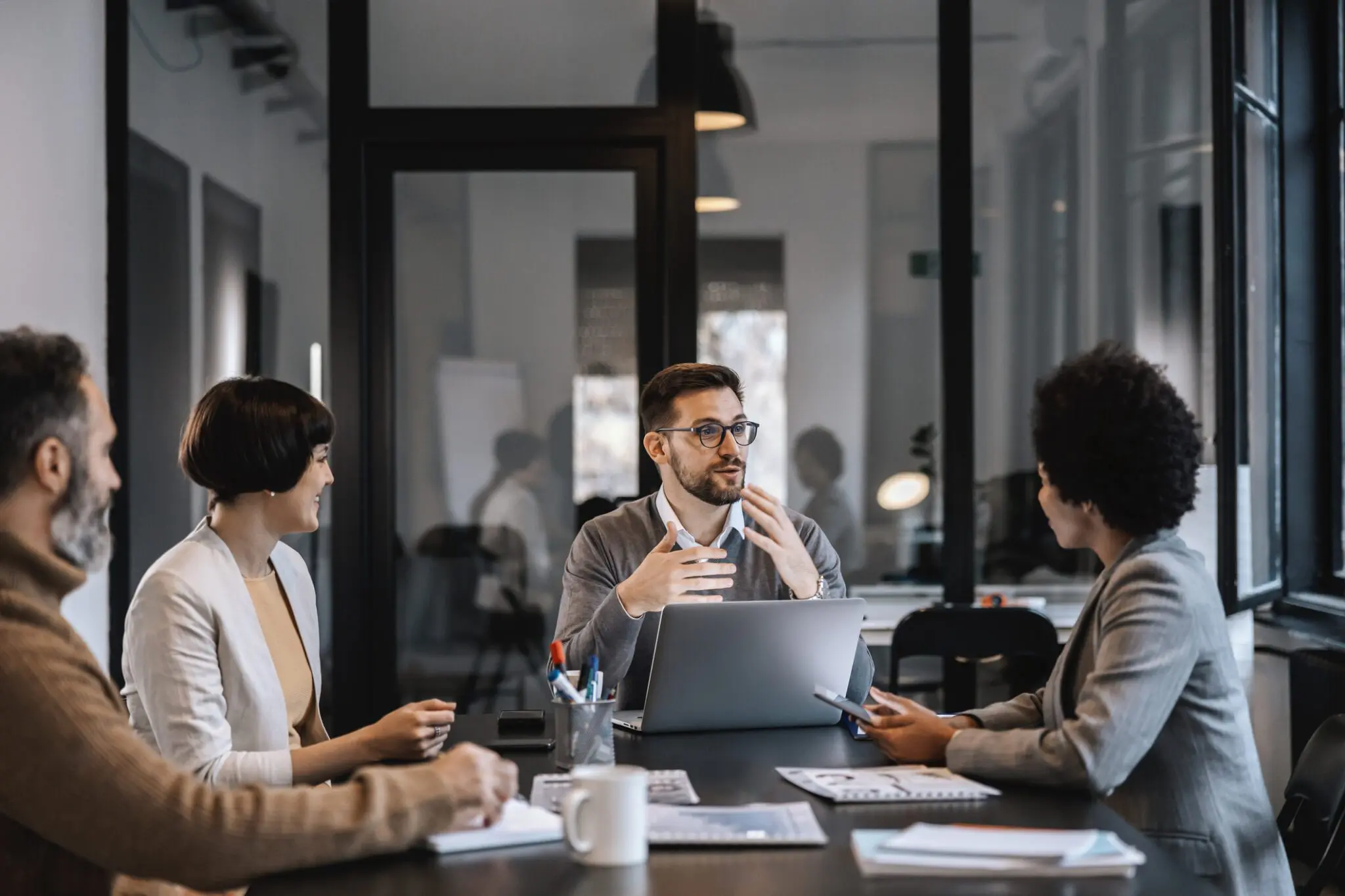 A team discusses ideas during a modern office meeting.