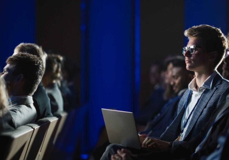 People engaged in a serious discussion in a conference room.