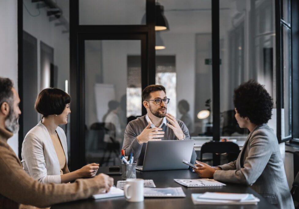 A team discusses ideas during a modern office meeting.